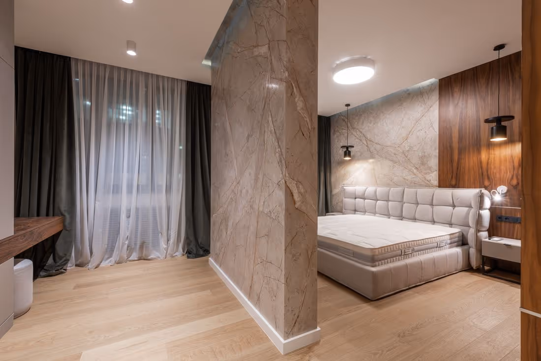 A row of clean, guest-ready hotel beds